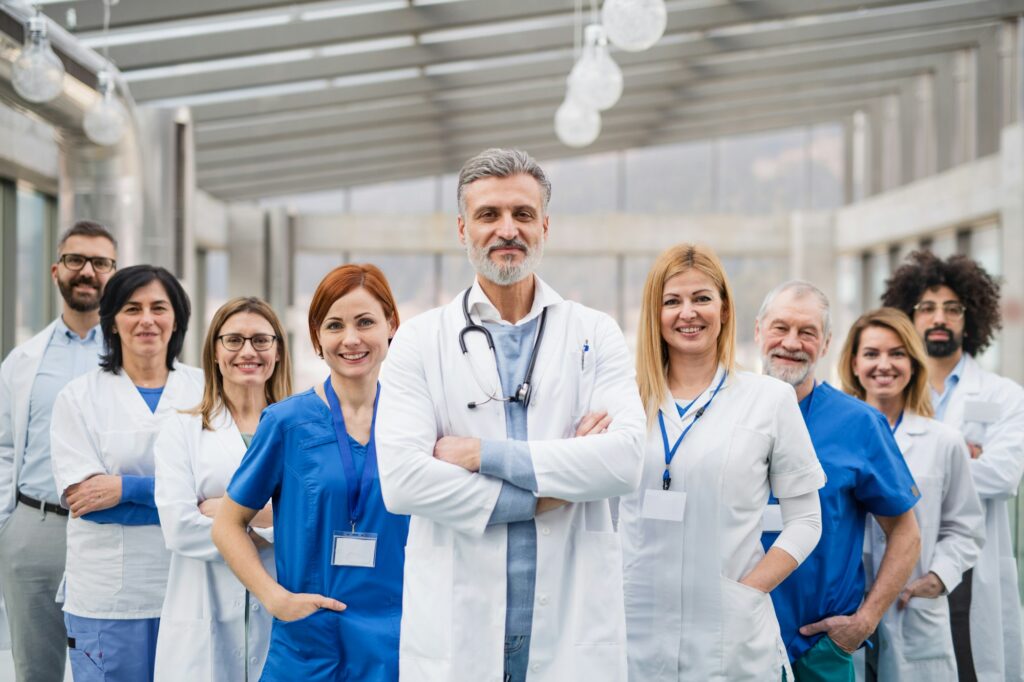 Group of doctors standing in hospital on medical conference.